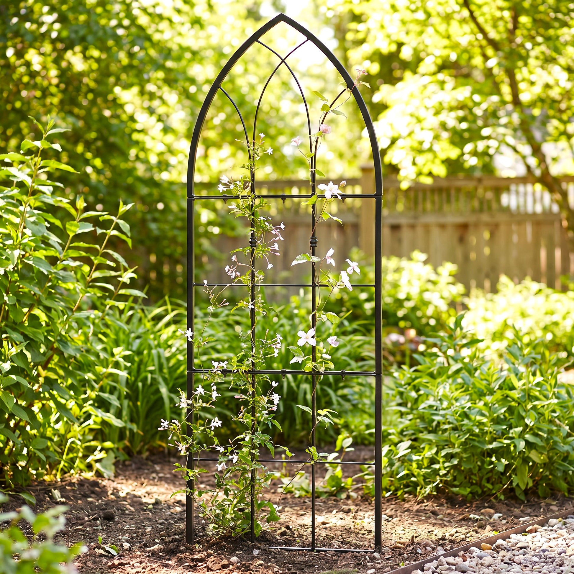 H Potter small gothic trellis in black finish in garden with vines