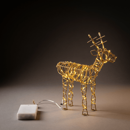 large led lighted gold reindeer on a table