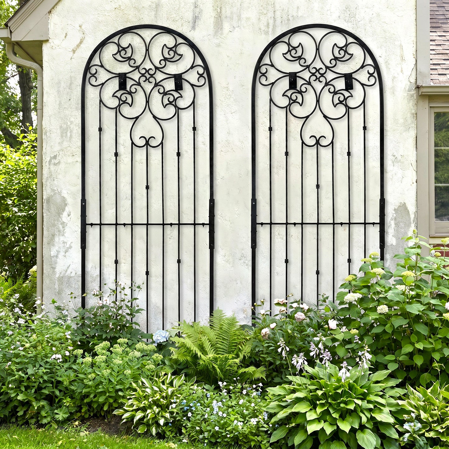 H Potter Legacy Wall trellis 8 ft tall black metal on stucco house above landscaped front yard garden