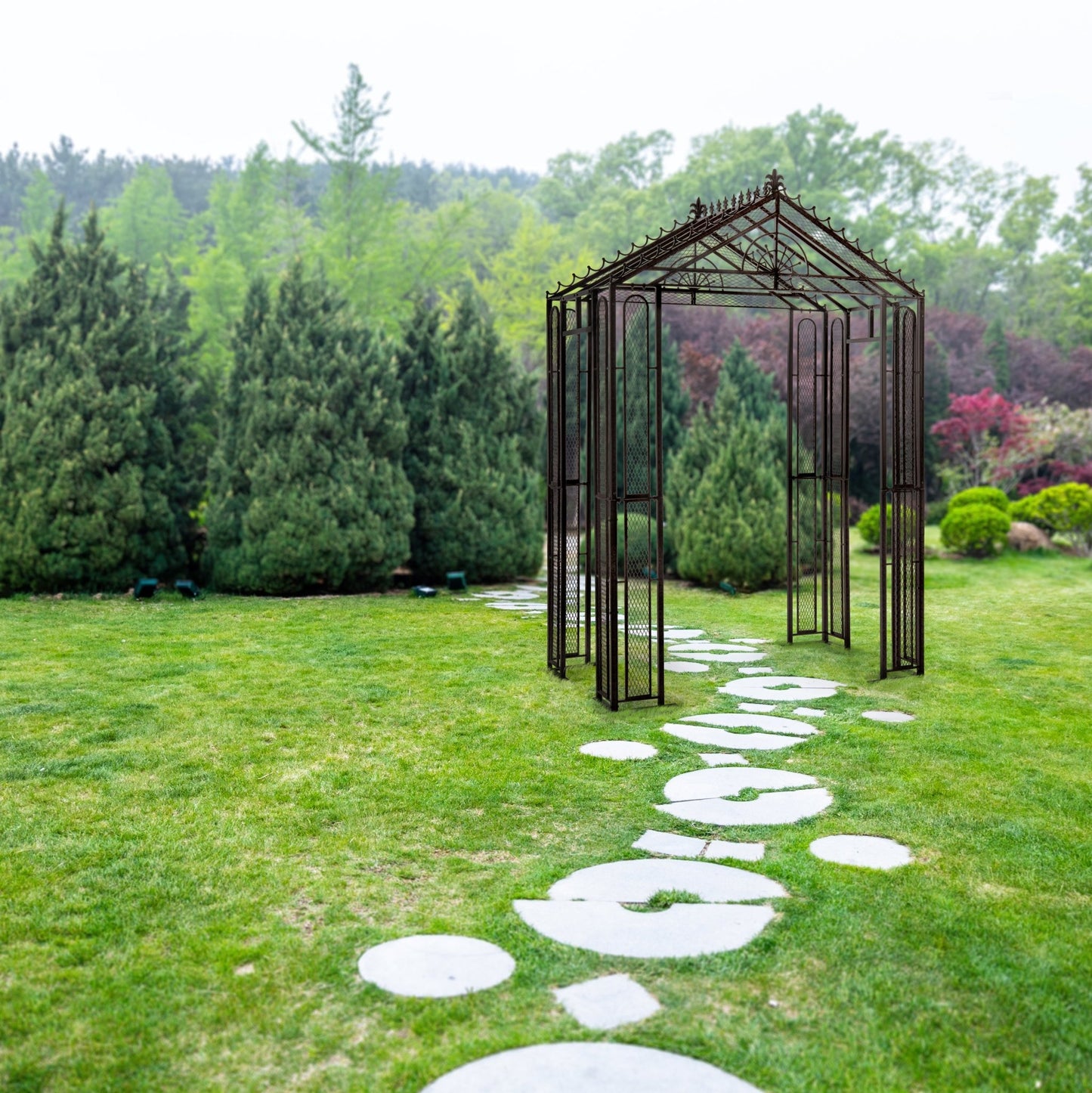 H Potter metal garden arbor trellis arch shown in a landscaped yard with stone path, ideal for supporting climbing plants outdoors.
