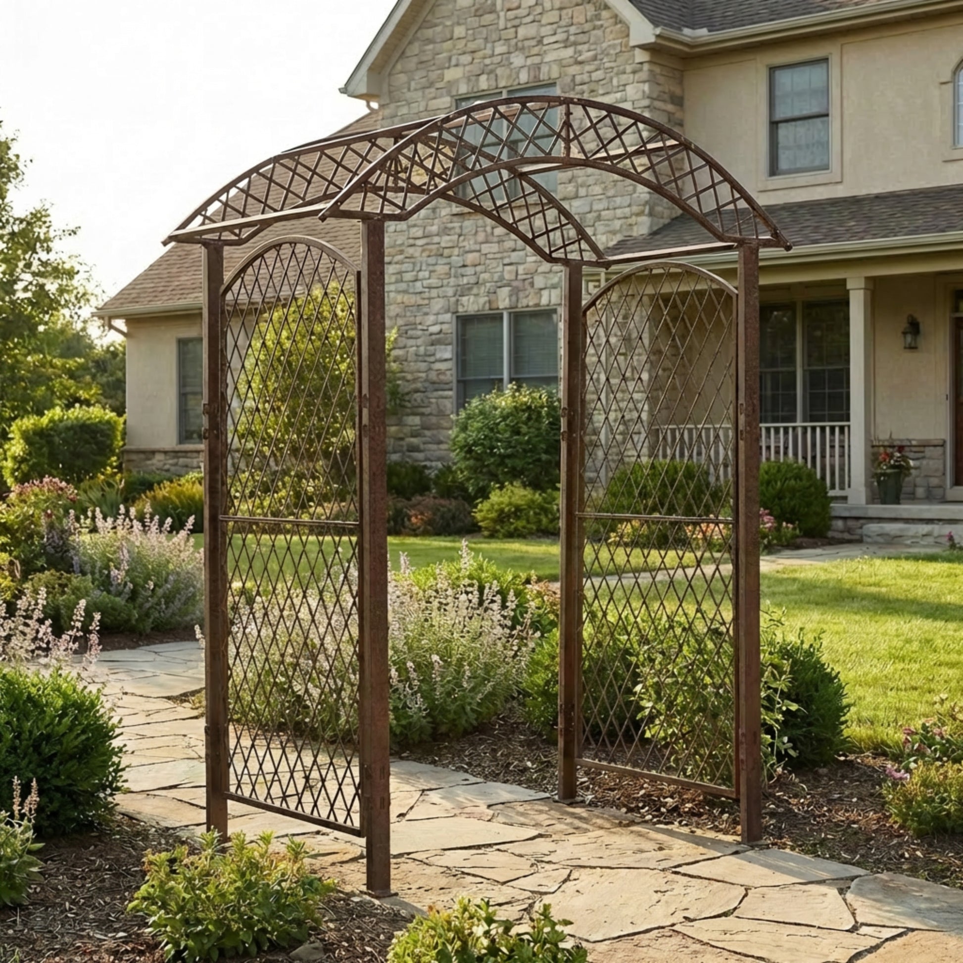 H Potter metal garden arbor arch with lattice side panels and curved top, creating an elegant entryway for garden paths and landscaping near a home.
