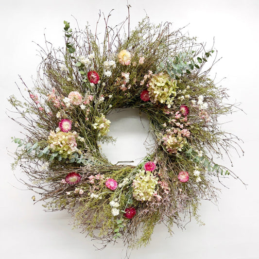 Floral wreath with colorful flowers on a white background