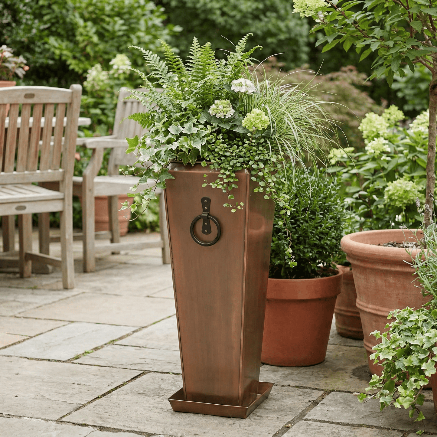 h potter garden planter on backyard patio with green plants