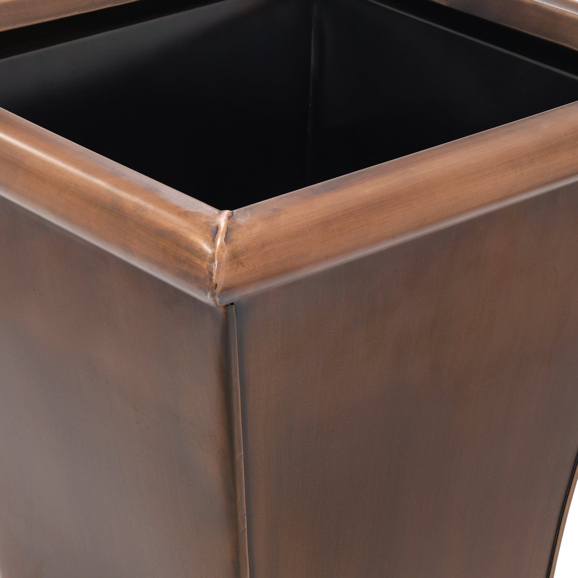 Close-up of h potter planter with a copper finish.