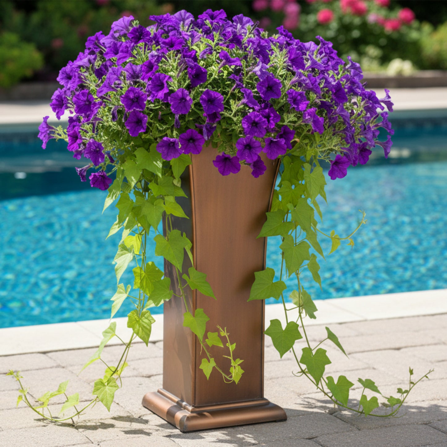 H Potter tall entryway urn planter by pool filled with purple petunias and sweet potato vines