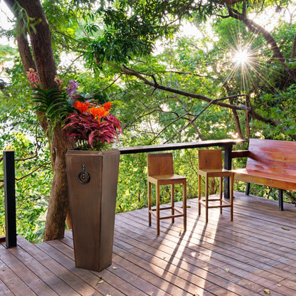H Potter tall copper planter styled with flowers on back deck