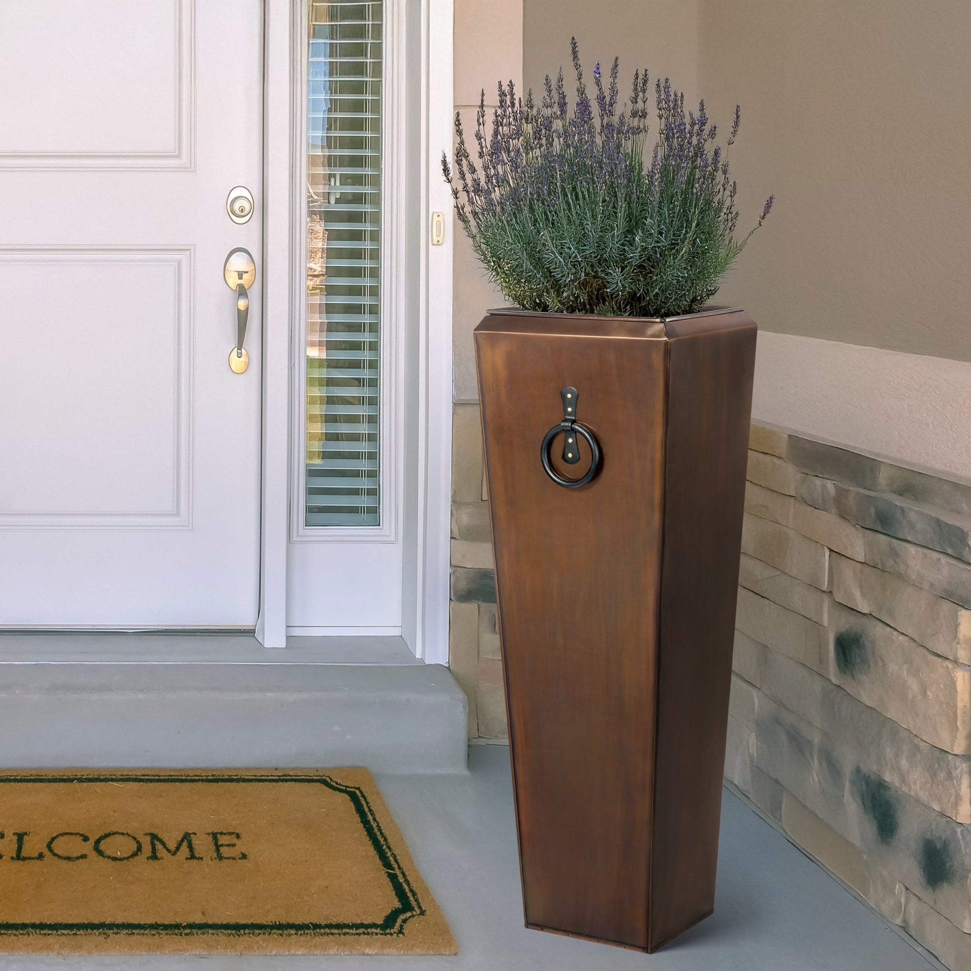 H Potter tall copper planter at front door entryway with plants