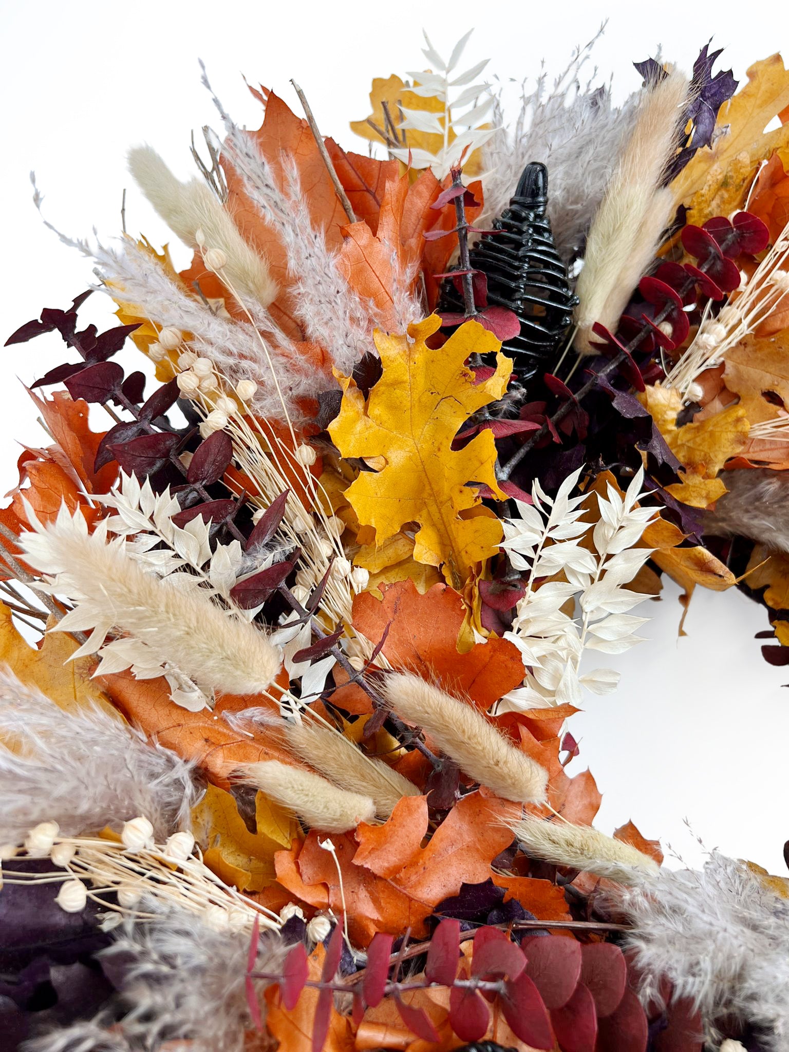 H Potter preserved wreath with autumn-themed floral arrangement with dried leaves and grasses on a white background