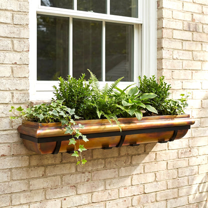h potter window box rustic copper with black mounting brackets under a window on a brick house