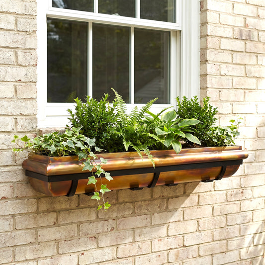 h potter window box rustic copper with black mounting brackets under a window on a brick house
