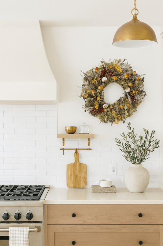 H Potter savory harvest dried fall wreath—dried artemisia, oregano, eucalyptus, tansy, safflower, chili peppers, garlic; on white kitchen wall