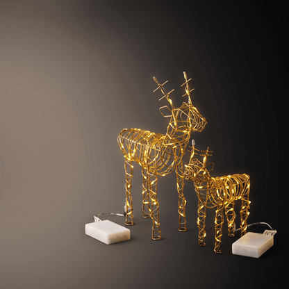 Two golden wire-frame deer sculptures with warm white LED lights, shown on a dark gradient background with two white battery packs.