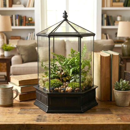 H Potter terrarium on a wooden table with books and a cup in a home setting