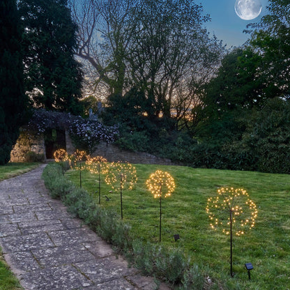 H Potter solar lights along a pathway in the moonlight