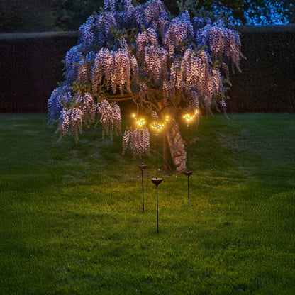 h potter solar staked sparrows in yard by a tree