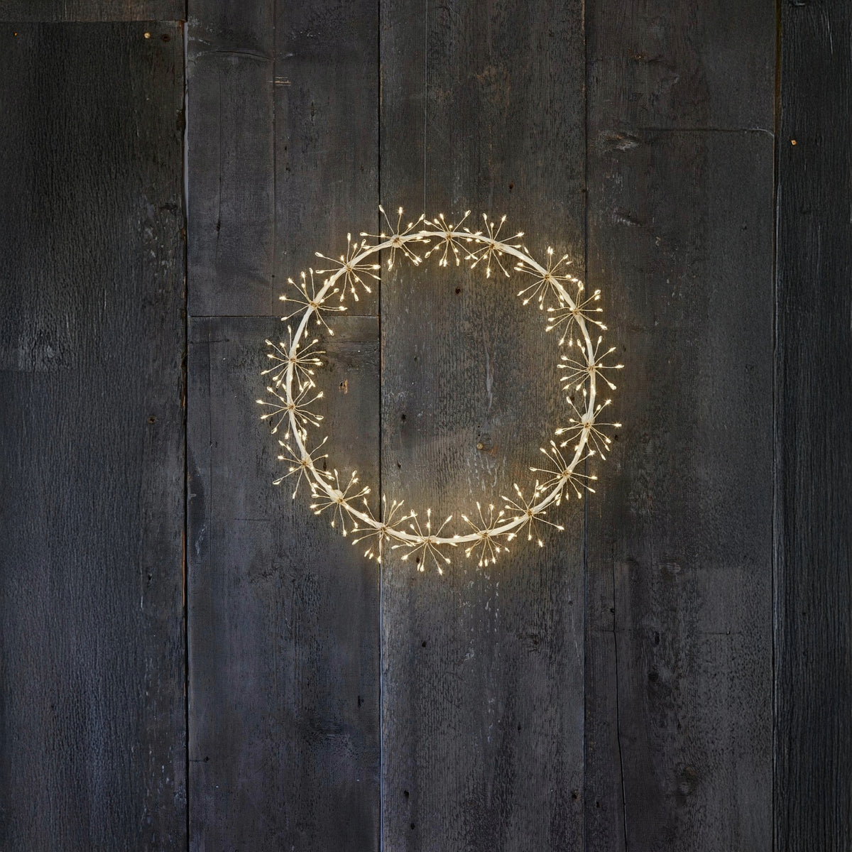 small h potter starlight led wreath on wooden wall