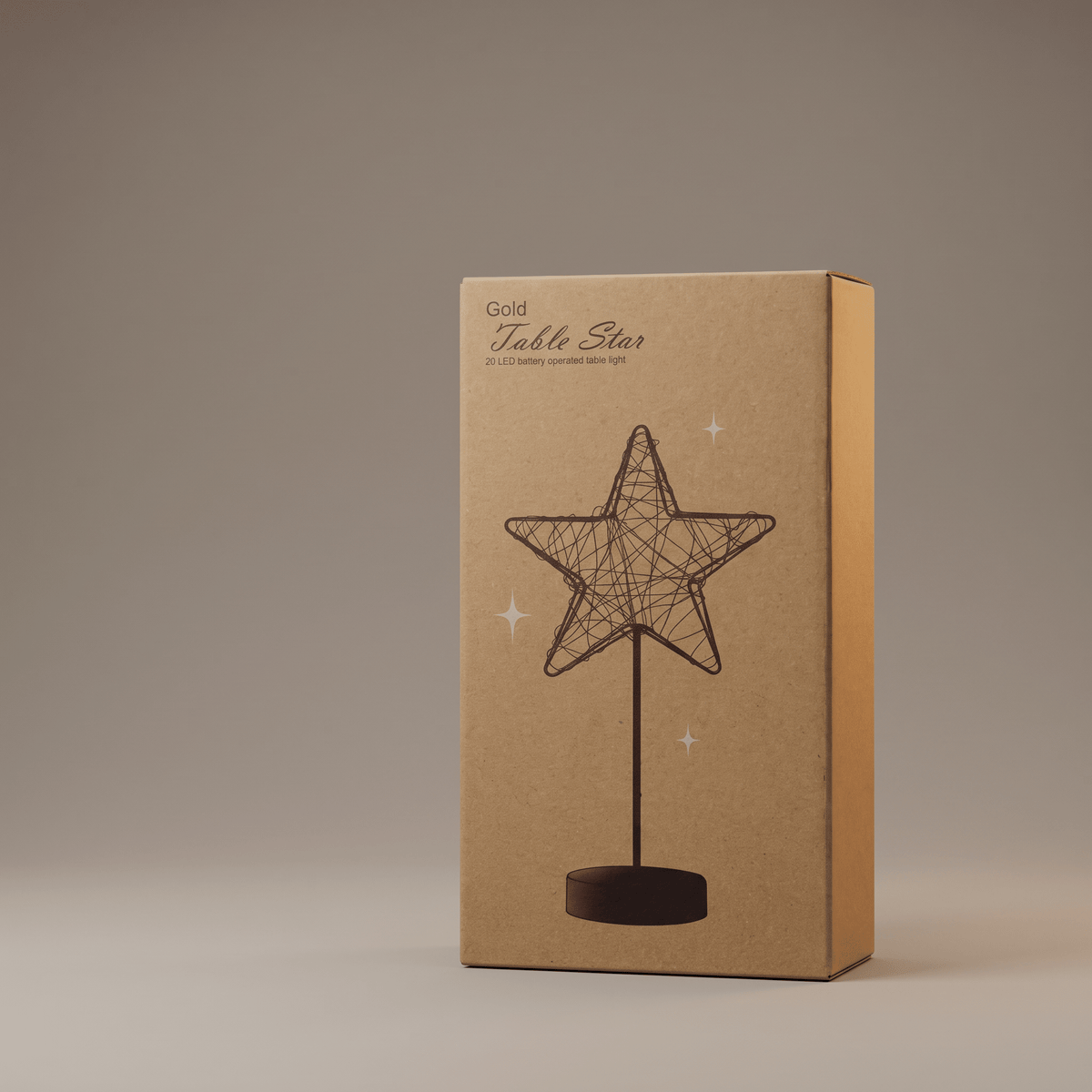 A rectangular kraft paper box standing upright on a neutral gray studio background. The box is labeled 'Gold Table Star' and features an illustration of a wire star on a stand with small starburst accents.