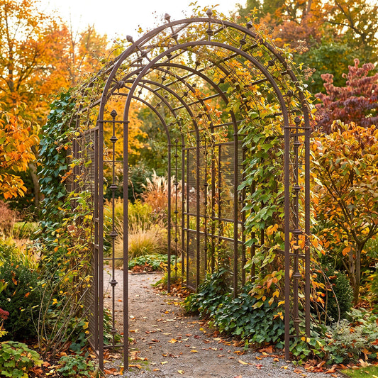 H Potter rustic metal arched garden trellis covered with climbing ivy, situated on a gravel path in a lush garden with vibrant autumn foliage.