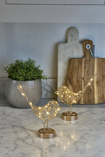 H Potter decorative LED bird-shaped lights on a marble surface in a kitchen with a plant and cutting board in the background.