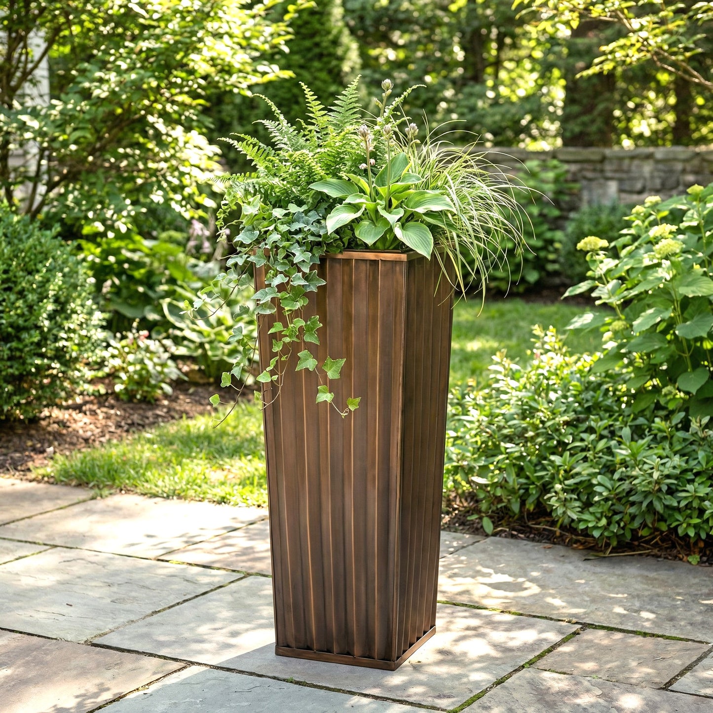 H Potter tall antique planter 29 inch height on stone patio with green plants
