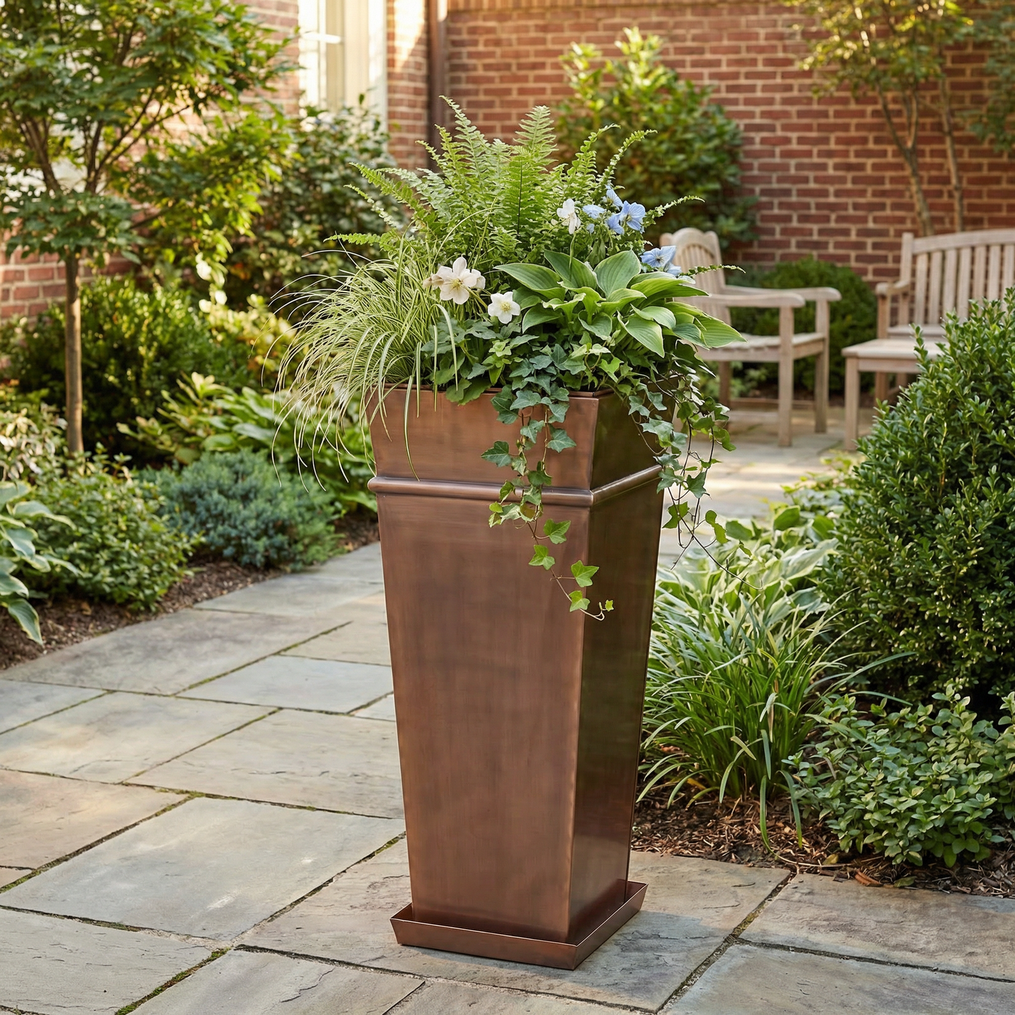 h potter tall garden planter outdoors on stone patio with green plants