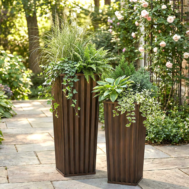 H Potter tall antique copper garden planter set outdoors on stone patio with green plants