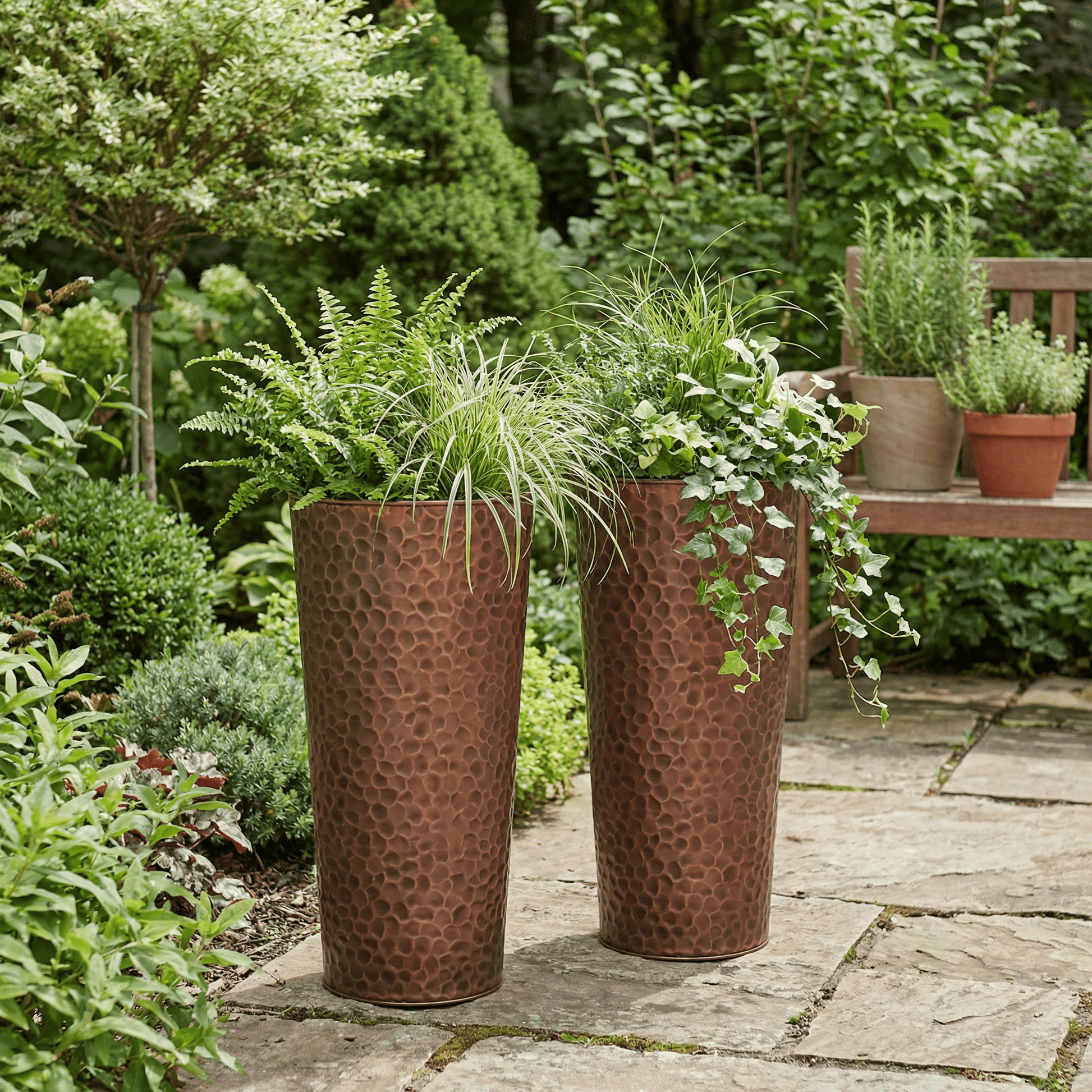 h potter column planter set of 2 on stone patio in a garden with green plants