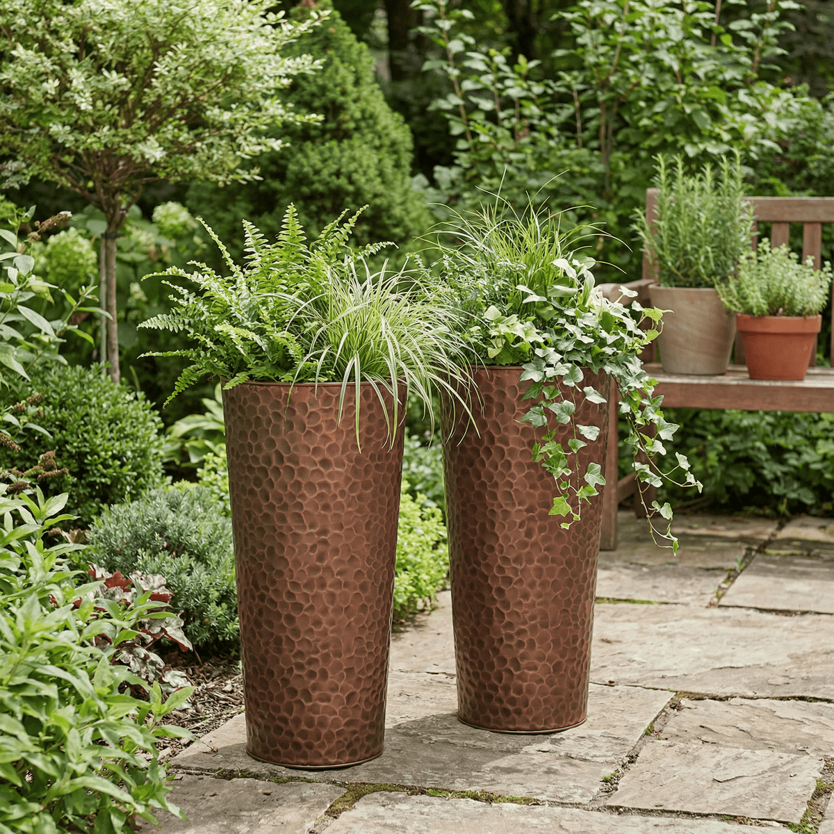 h potter tall copper garden planter set on a stone patio