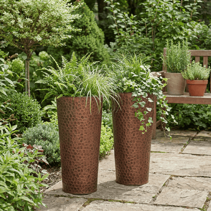 h potter tall copper garden planter set on a stone patio