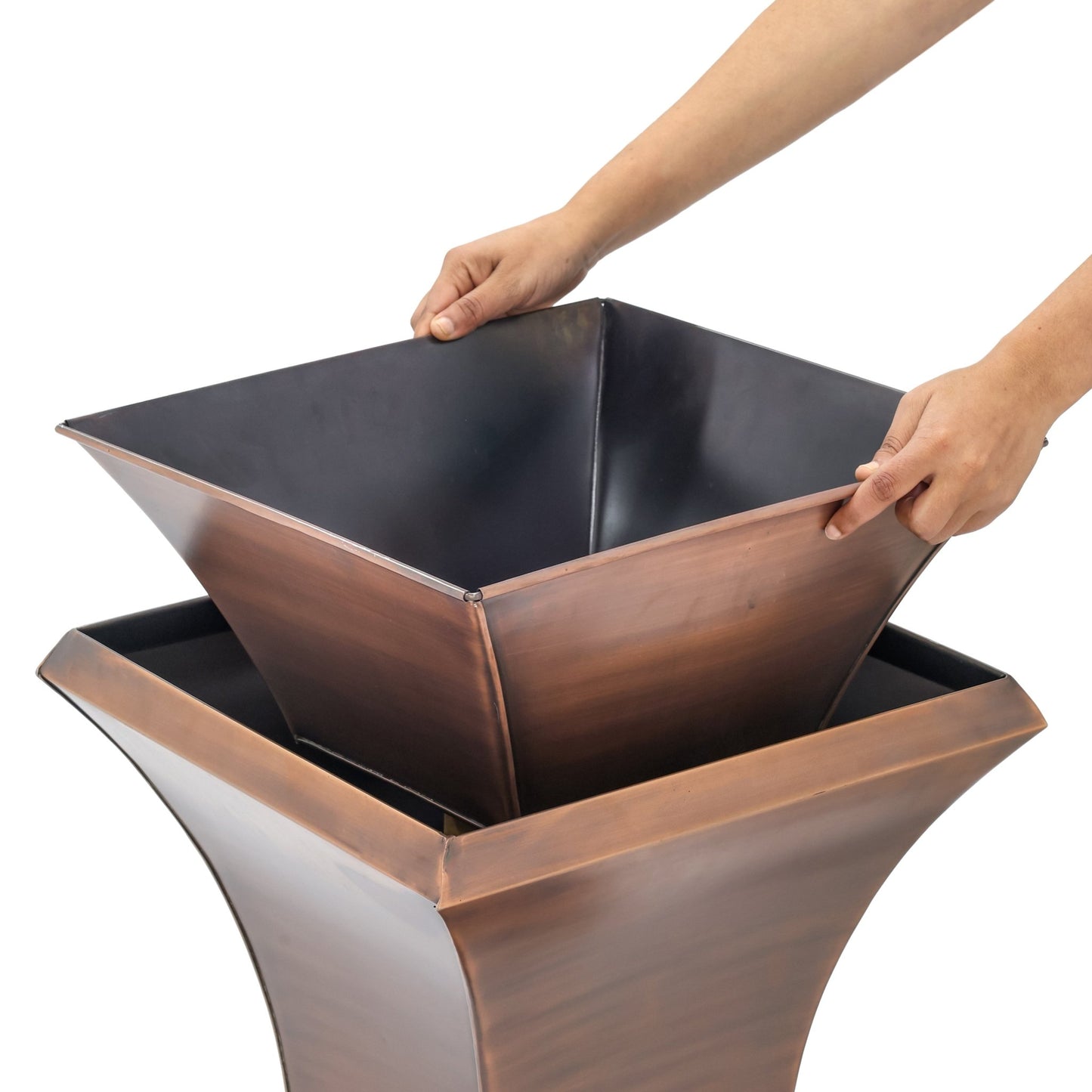 H Potter tall copper garden urn planter showing a person removing the custom planting insert