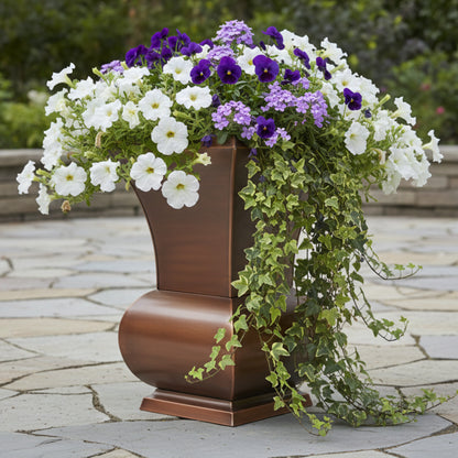 H Potter tall garden urn planter on a stone patio filled with white and purple petunias and green ivy