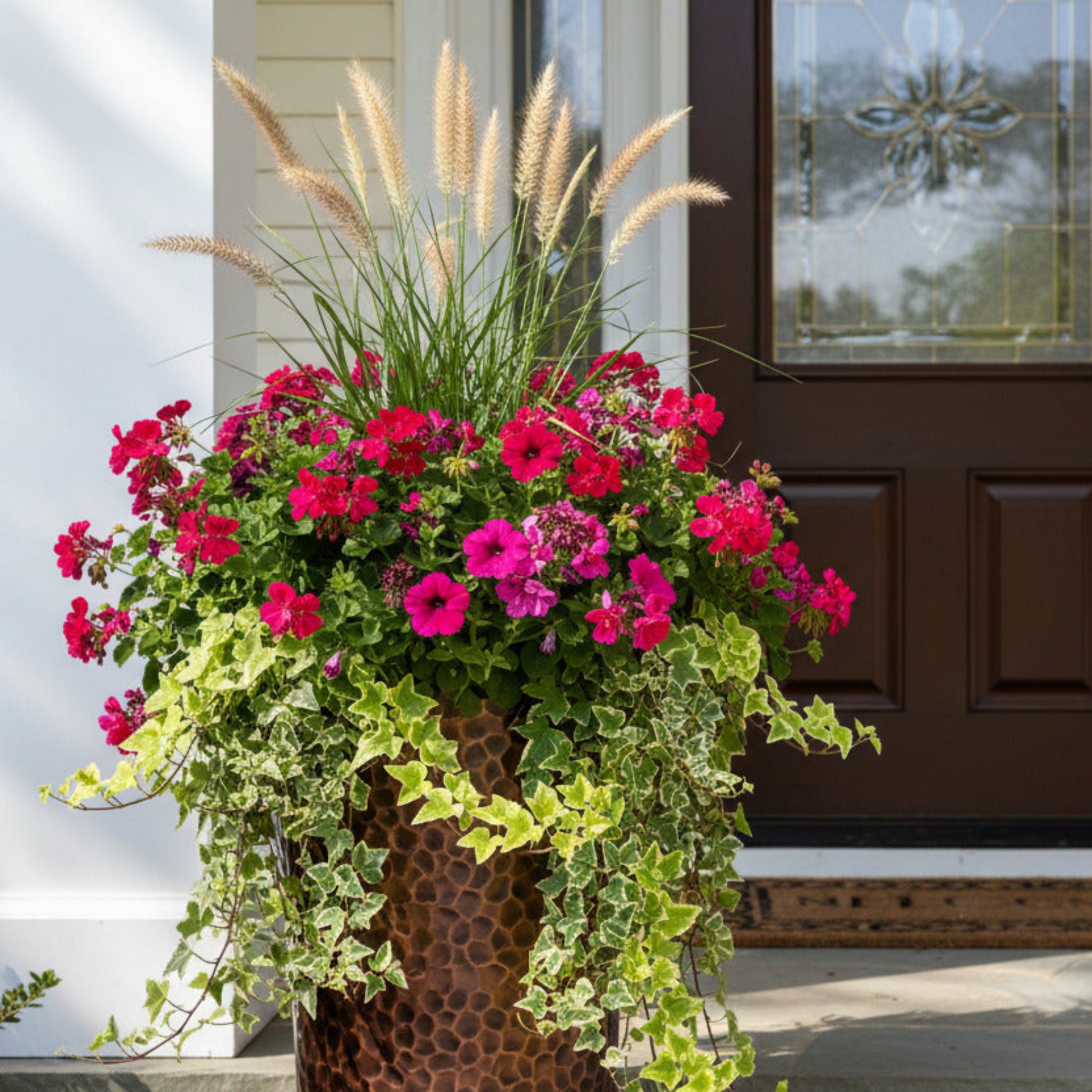 Tall Planter at front door with thriller spiller flowers