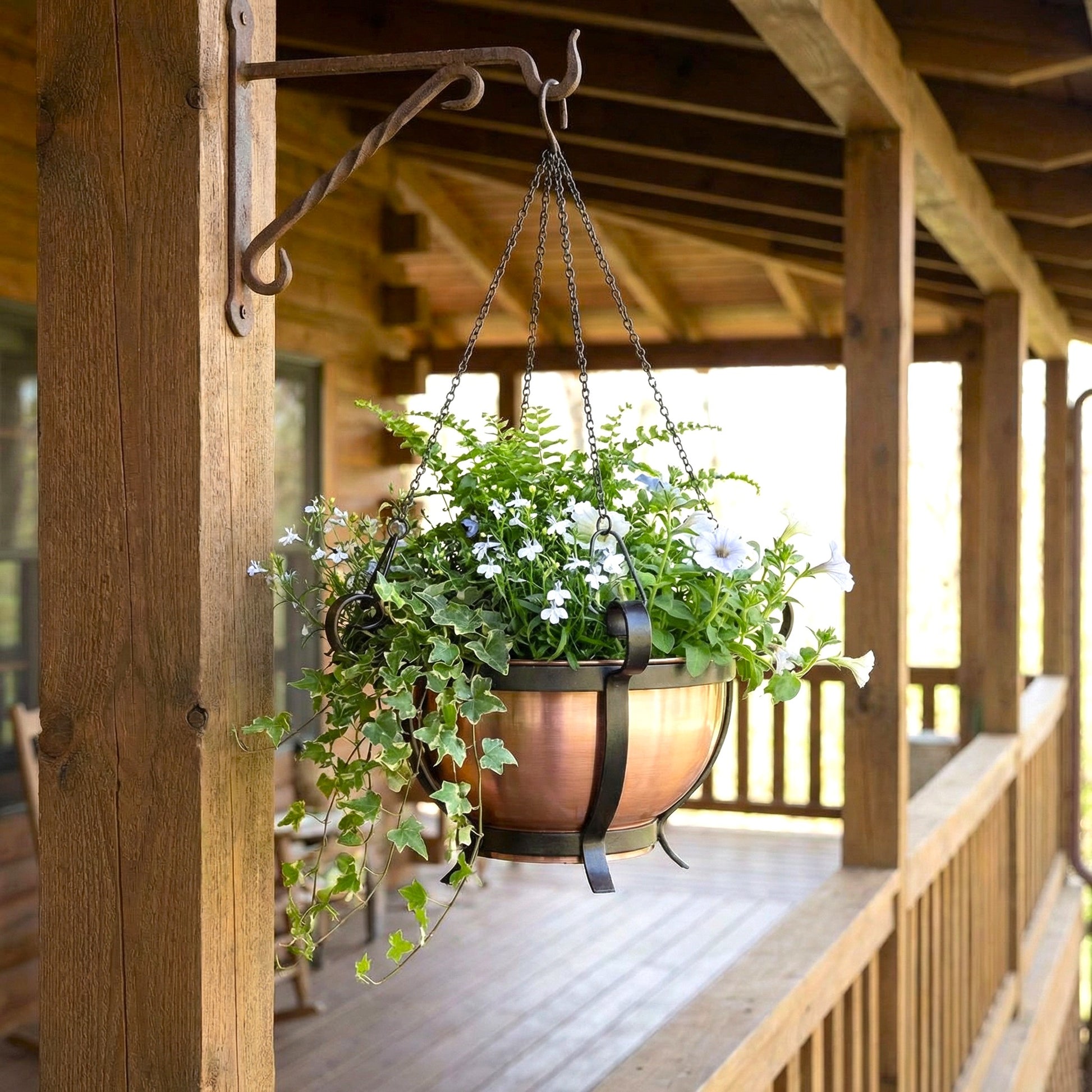 H Potter Traditional Round Copper Hanging Planter on a deck with flowers