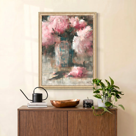 Framed abstract painting on a wall above a wooden cabinet with decorative items.
