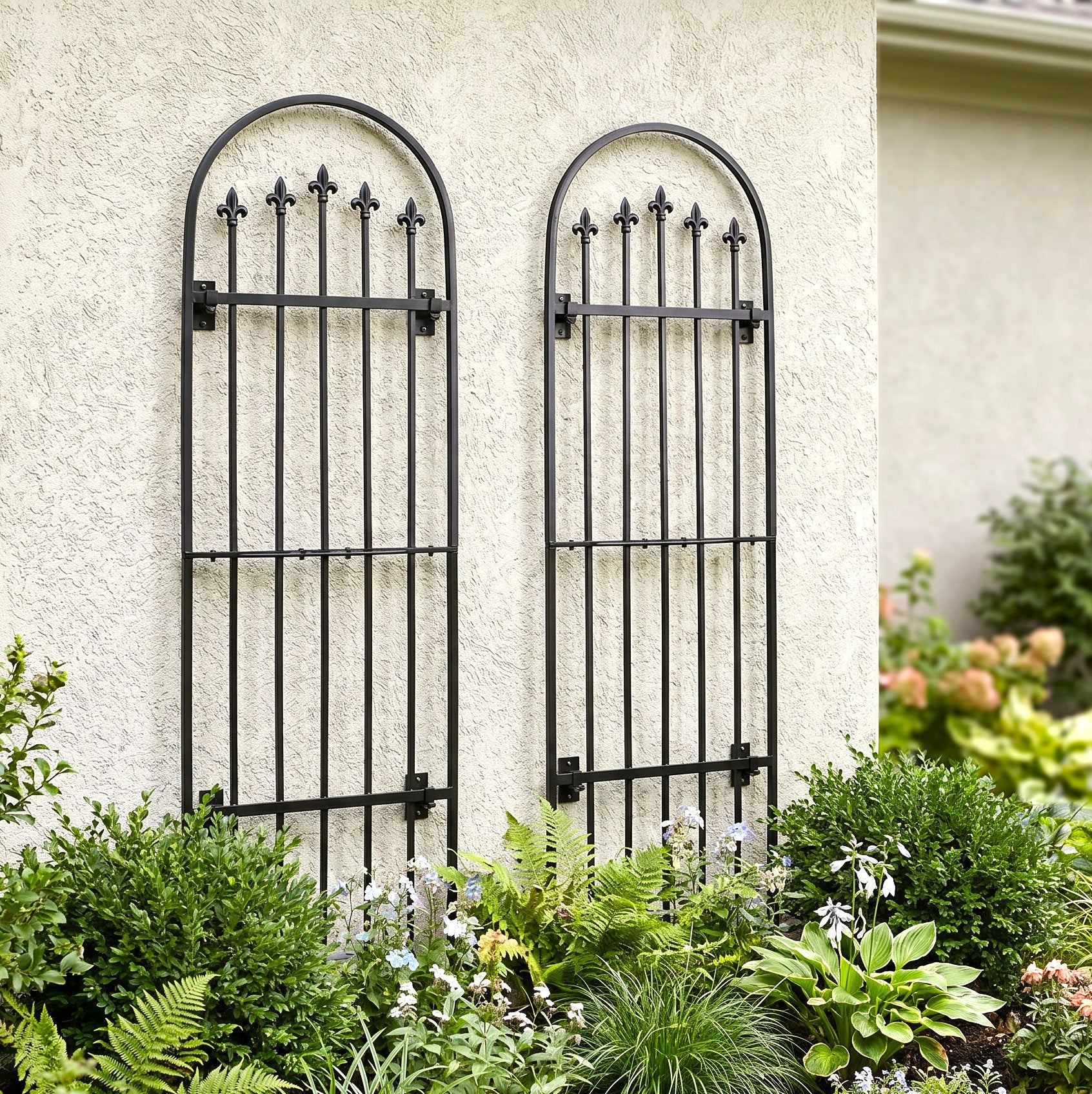 H Potter Verona Wall trellis set on stucco house above landscaping