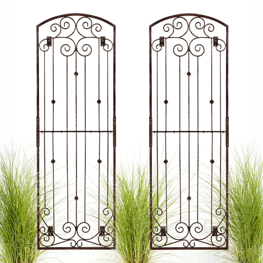 Two H Potter metal garden trellises with intricate designs on a wall.