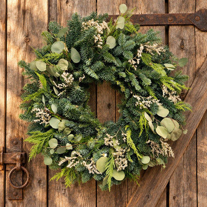h potter winter wreath on a barn door