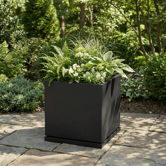 h potter Willow black square planter on stone patio 
