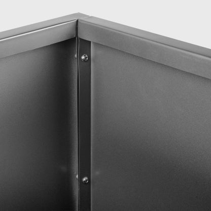 Close-up of a metallic corner with screws on a gray background