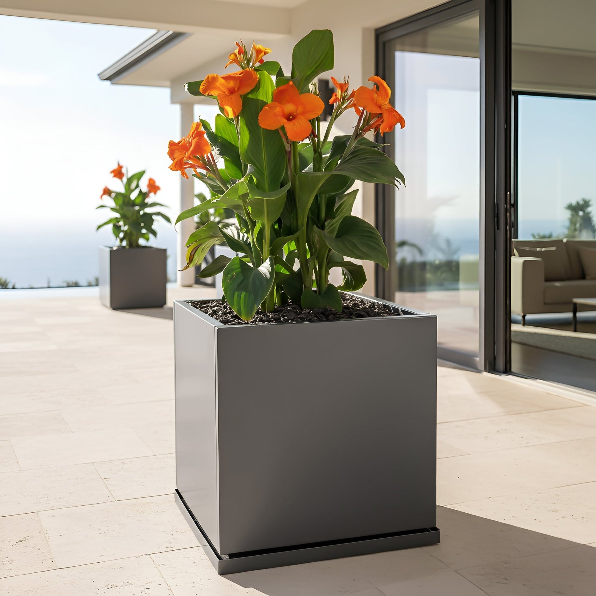 H Potter 20" Gray Square Metal Planter with orange flowers on modern patio