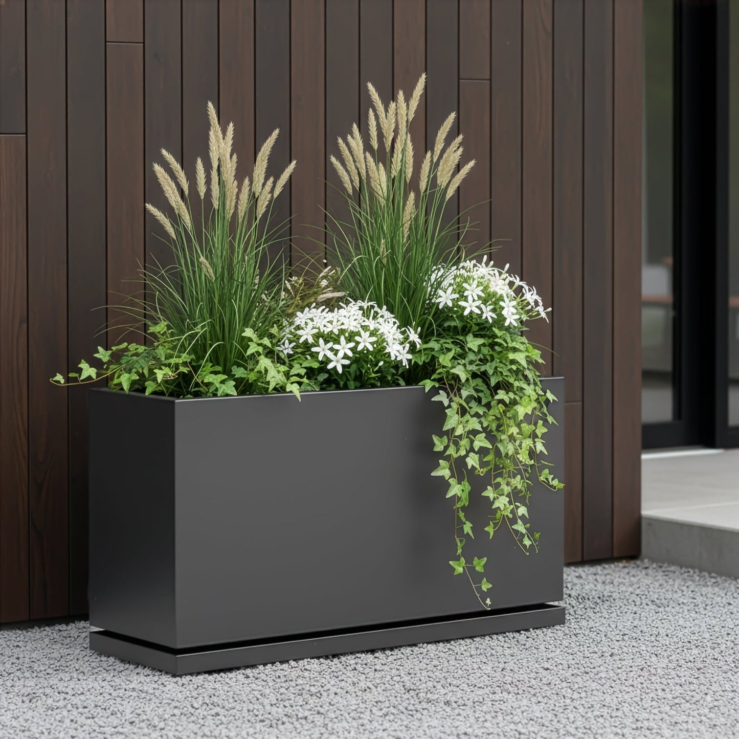 H Potter metal planter in gray finish with plants in back patio