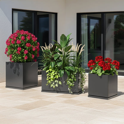 Three H Potter grey planters with flowers on a contemporary patio