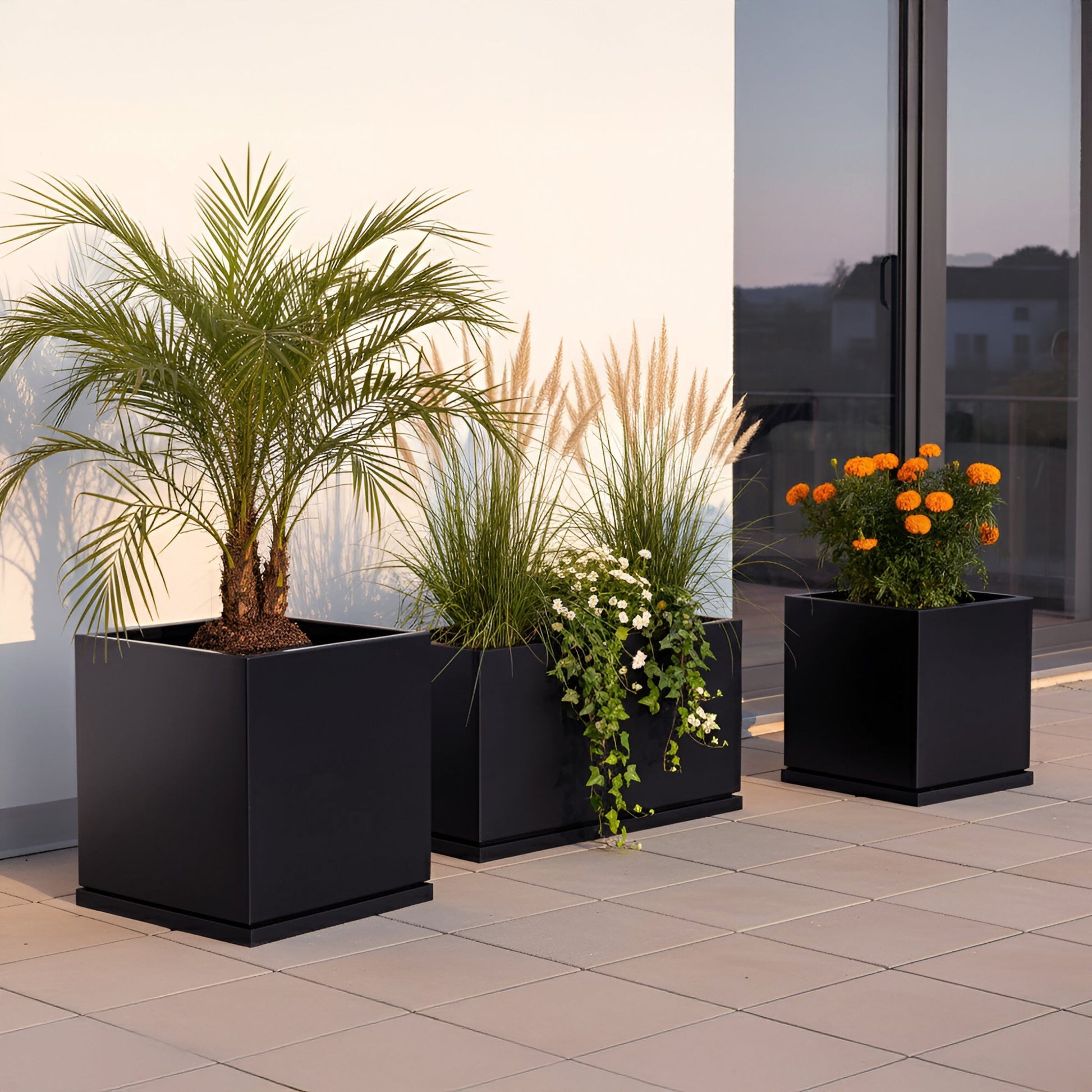 h potter 3 black planters on a contemporary patio