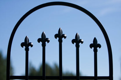 Top arch and five finials detail on H Potter black powder-coated garden trellis, modern clean lines