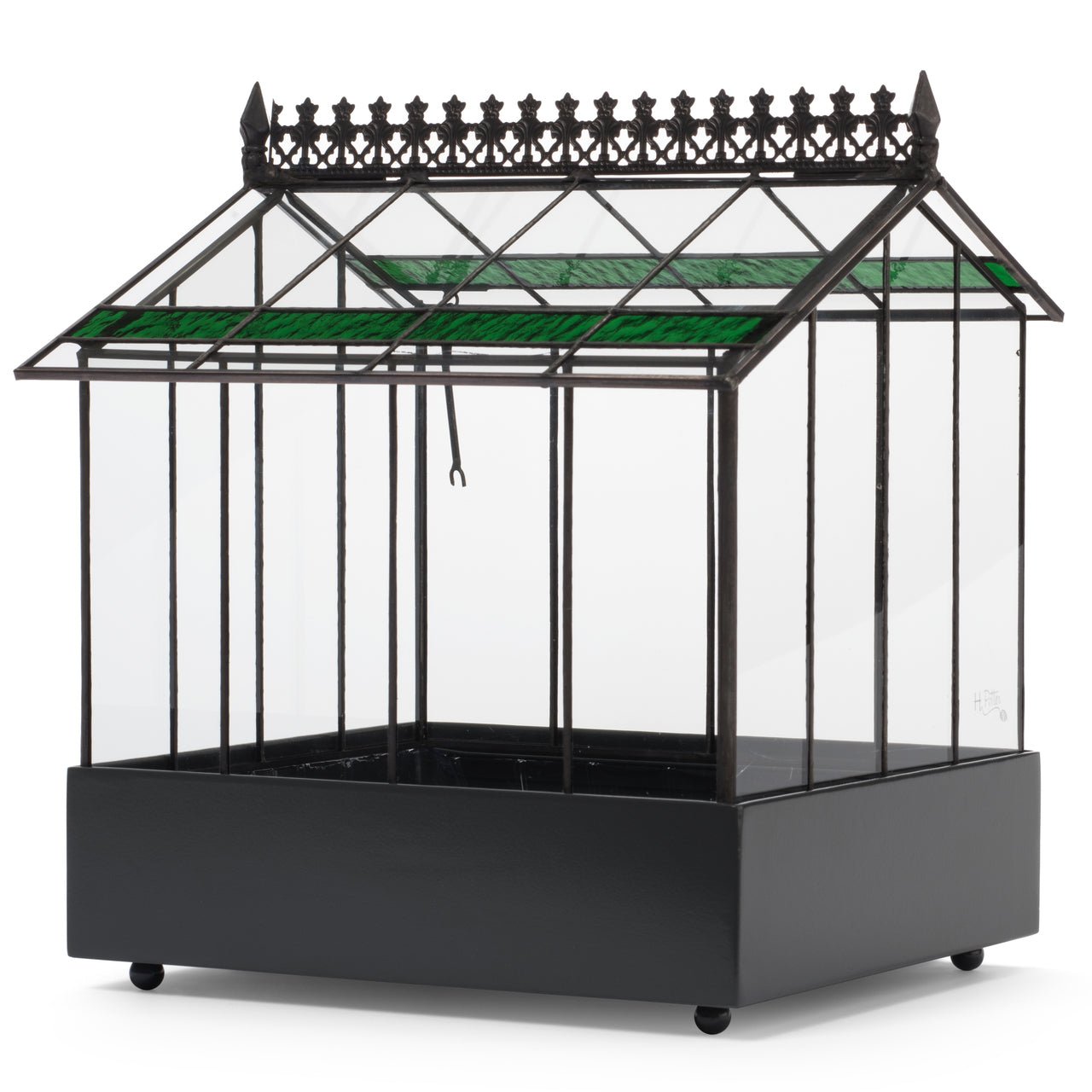 A detailed close-up of the intricate Victorian-style metal cresting along the ridge of the H Potter glass terrarium roof.