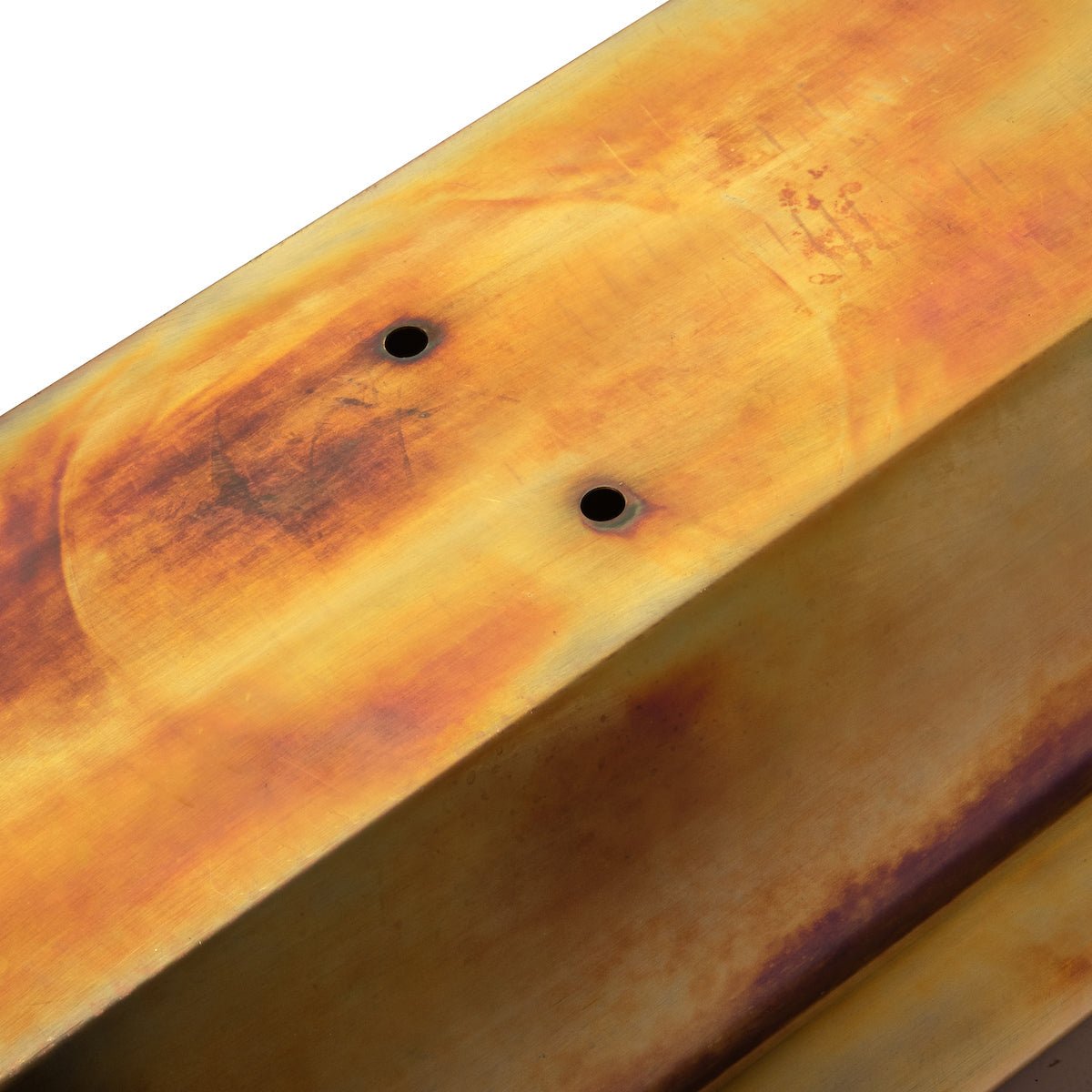 Close-up of rustic copper finish on metal window box planter drain holes