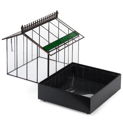 The glass top of the H Potter terrarium lifted off its deep black powder-coated metal tray, showing the two-piece construction.