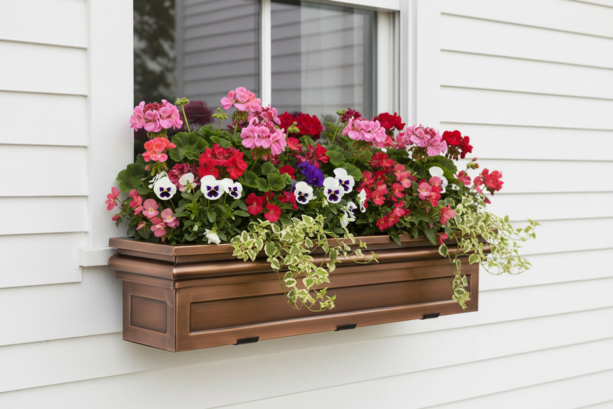 H Potter Williamsburg Window Box on a white house filled with zonal geraniums, begonias, pansies